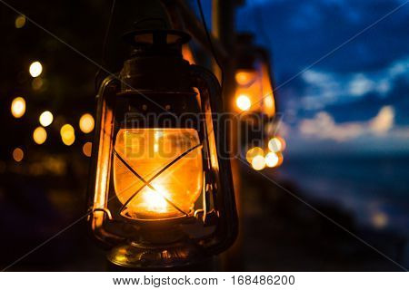 Sunset on an island beach with lanterns illuminating the romantic scene