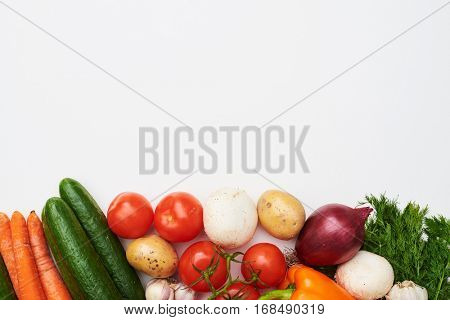 Overhead shot of raw organic vegetables with fresh ingredients for healthily cooking on. Vegan or diet food concept. Background layout with space