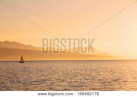 Boat sailing at sunset on lake Geneva