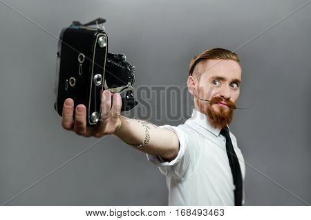 stylish the guy with the long whiskers makes selfie