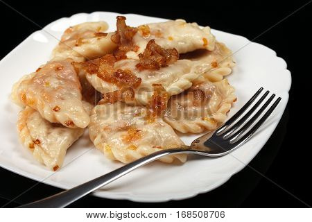 Traditional Ukrainian dumplings with bacon and cabbage.