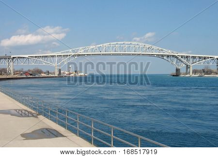 The two spans of the Blue Water International Bridge carry traffic across the St. Clair River near its juncture with Lake Huron. Port Huron Michigan USA is on the left and Sarnia Ontario Canada is on the right.