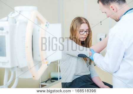 Doctor Examining Broken Arm and Preparing For Xray Imaging. Healthcare Photo Concept.