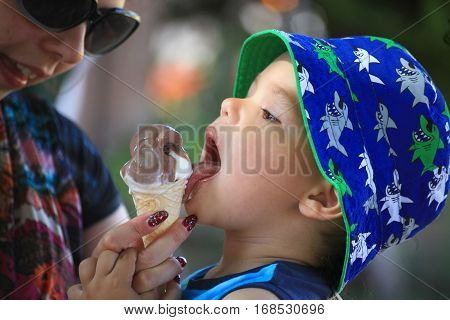 DIDIM TURKEY - JULY 9 2014. Casual portrait of a cute toddler with an ice cream cone.