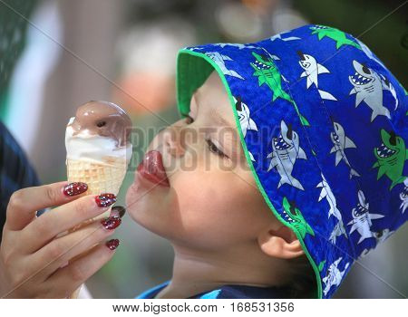 DIDIM TURKEY - JULY 9 2014. Casual portrait of a cute toddler with an ice cream cone.