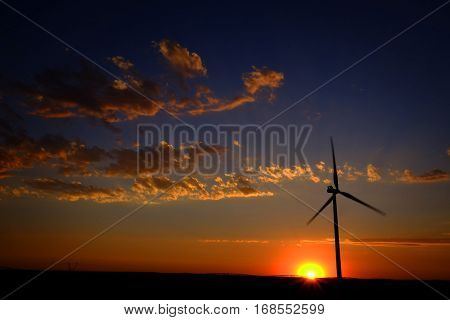 Power generated by wind with winmill blowing sky clouds sunset sunrise