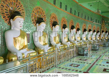 SAGAING, MYANMAR - DECEMBER 20, 2016: Gallery of statues of sitting Buddhas cave pagoda U Min Thonze Temple