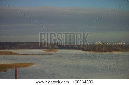 distant ancient white brick citadel behind the forest