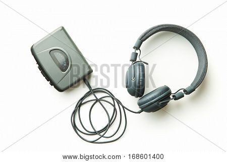 Vintage audio player and headphones isolated on white background.