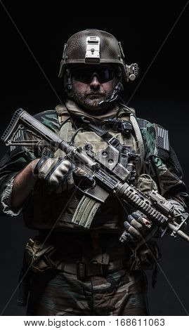 United states Marine Corps special operations command Marsoc raider with weapon. Studio shot of Marine Special Operator black background