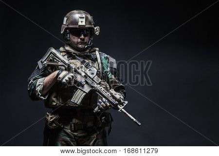 United states Marine Corps special operations command Marsoc raider with weapon. Studio shot of Marine Special Operator black background