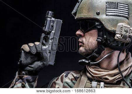 United states Marine Corps special operations command Marsoc raider with pistol. Studio shot of Marine Special Operator black background