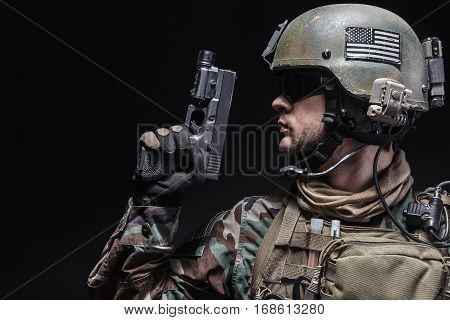 United states Marine Corps special operations command Marsoc raider with pistol. Studio shot of Marine Special Operator black background
