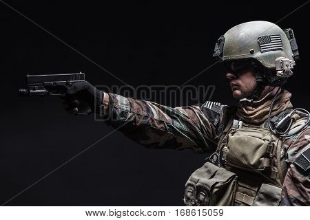 United states Marine Corps special operations command Marsoc raider with pistol. Studio shot of Marine Special Operator black background