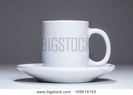 White porcelain coffee cup on a grey background