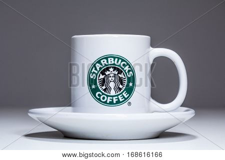 BELGRADE SERBIA - FEBRUARY 03 2017 : Starbucks coffee cup in porcelain isolated on grey background in studio