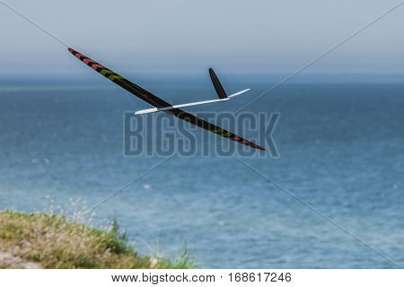 RC remotely controlled soaring plane model sailplane on blue sky in brisk wind