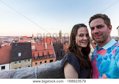 View of a couple taking selfie in Nuremberg in the evening