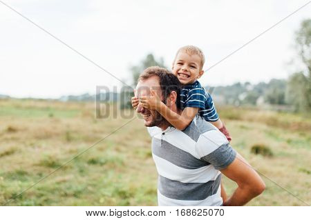 Father And Son In Nature In Summer Park
