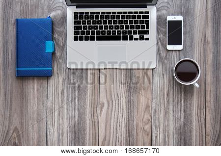 Top view office desk mockup with laptop, smartphone, coffee and notepad