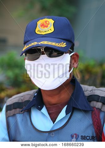CHIANG MAI, THAILAND. February 25, 2010: Everyday life in Northern Thailand. Closeup portrait of young police officer in the form near the Buddhist temple in Chiang Mai.