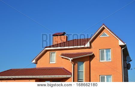 New Modern Brick House Facade Exterior. Modern House Construction. Hip and Valley roofing types.
