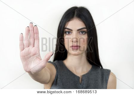 Business woman with her arm to the front making the stop sign.