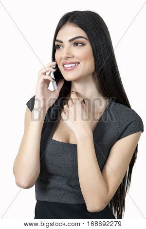 Young business woman talking on the phone and smiling.