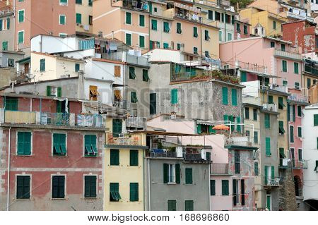 Riomaggiore the most southern village of the five Cinque Terre in Italy all connected by rail. The water and mountainside have been declared national parks.