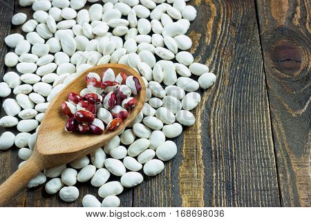 White Beans On A Wooden Table And Wooden Spoon