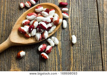 White Beans On A Wooden Table And Wooden Spoon