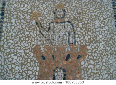 Beautiful large patterned pebble stone mosaic arranged in a symbol on pavement pedestrian street in Nice Cote d'Azur France