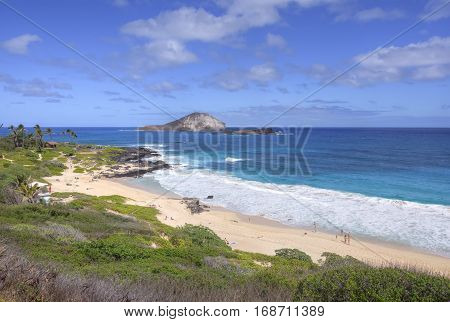 MAKAPU'U BEACH OAHU HAWAII - JANUARY 27 2017: Makapu'u Beach on Oahu's southeast coast is a fantastic getaway with good surf in turquoise blue water and beautiful views of nearby islands.