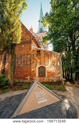 Riga, Latvia - July 01, 2016: Pyramidal Monument To Barricades And Perished People On January 20 1991 On Jekaba Street. Political Confrontations Between Latvian And Soviet Forces. St. James Cathedral Behind.
