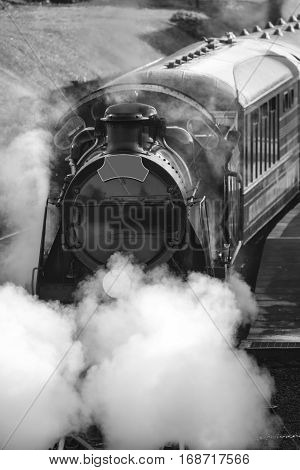 Restored Victorian Era Steam Train Engine With Full Steam In Black And White