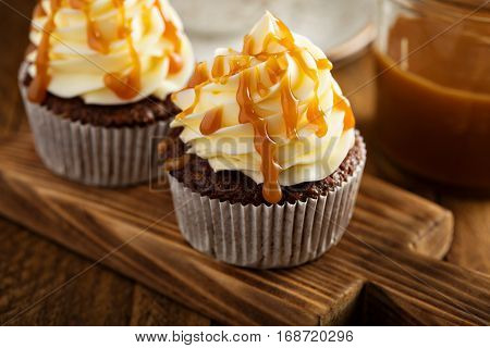 Homemade butterscotch cupcakes with caramel syrup and cream cheese frosting