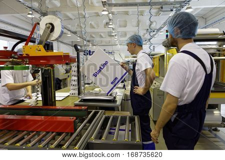 ST. PETERSBURG, RUSSIA - NOVEMBER 2, 2016: People at work in the department of packaging of products of StarLine company. It is one of the leading company on the automotive security market of Russia