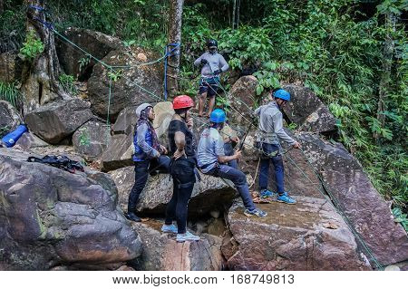 Beaufort,Sabah,Malaysia-Jan 28,2017:Group of canyoneer get ready to abseil down a waterfall in Beaufort,Sabah,Borneo.Waterfall Abseiling activity adventure getting famous in Sabah,Malaysia.