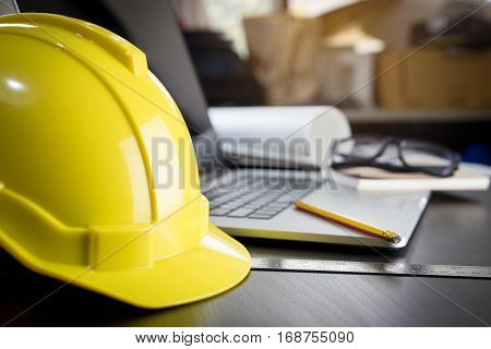 Engineering working desk with yellow safty helmet