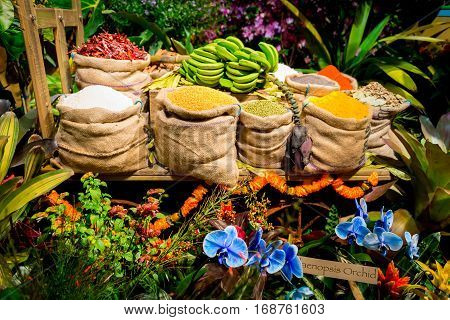 Flowers surrounding numbers of bags of beans
