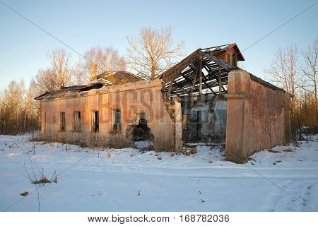 The destruction of an abandoned building public baths on a January evening. Working village Russian America mining of peat in the Leningrad region. Russia