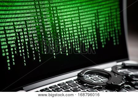 Hacking Concept. Handcuffs On Laptop