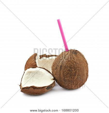 Single whole coconut with a pink drinking straw next to other broken coconut pieces, composition isolated over the white background