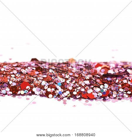 Copyspace backgdrop composition made of colorful and bright pile of sequins isolated over the white background