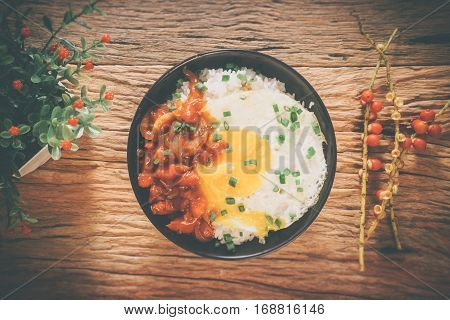Rice With Fried Egg And Tomato Sauce On Table Vintage Wooden Surface Top View