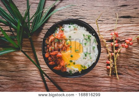 Rice With Fried Egg And Tomato Sauce On Table Vintage Wooden Surface Top View