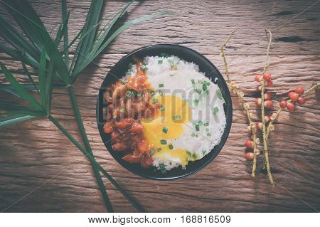 Rice With Fried Egg And Tomato Sauce On Table Vintage Wooden Surface Top View