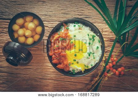 Rice With Fried Egg And Tomato Sauce On Table Vintage Wooden Surface Top View