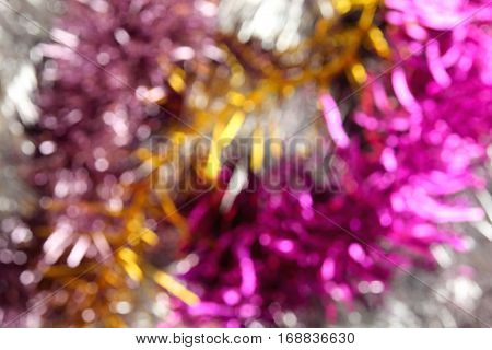 abstract festive christmas multicolored background from bright defocused tinsel with bokeh