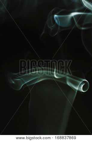 The swirls of smoke in the form of a manuscript closeup.